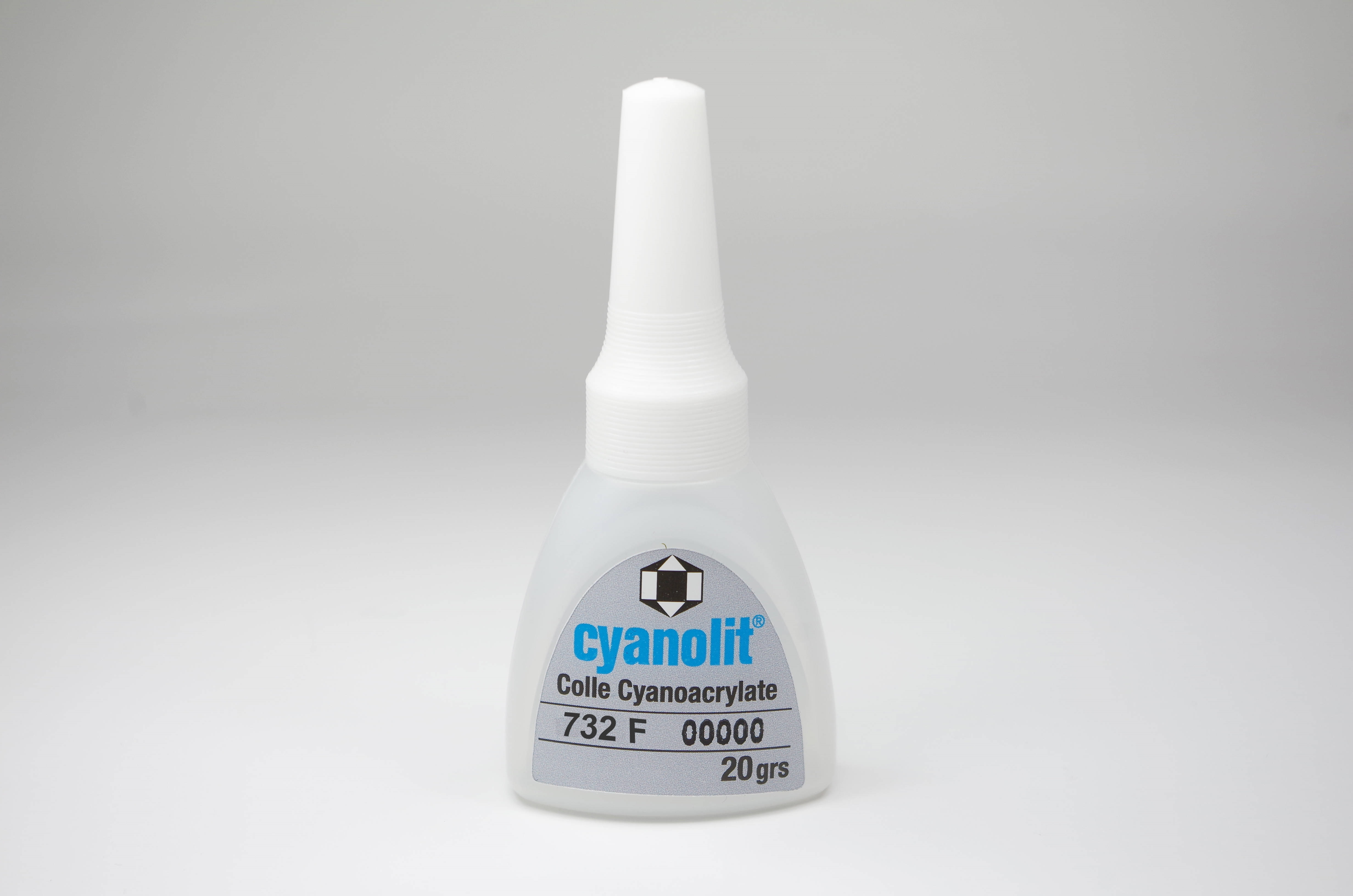 Transparente Flasche Cyanolit Sekundenkleber 732F mit weißer konischer Kappe auf hellem Hintergrund. Etikett: blau „cyanolit“, schwarz „Colle Cyanoacrylate 732 F“ und „20 grs“. Dünnflüssig, für poröse Oberflächen.