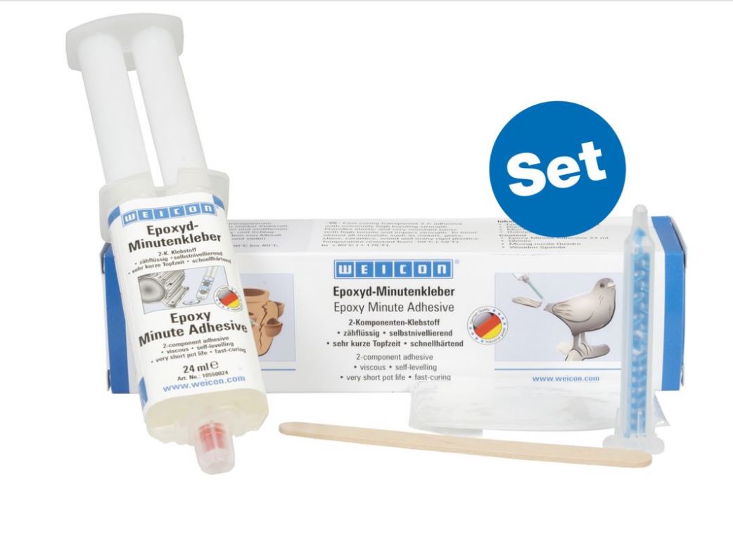 WEICON Epoxyd-Minutenkleber-Set: weiße Doppelspritze, Produktverpackung im Hintergrund, transparente Quadro-Mischdüse mit blauem Inhalt und Holzspatel. Verpackung zeigt Marke und Anwendungen für schnelle Reparaturen.